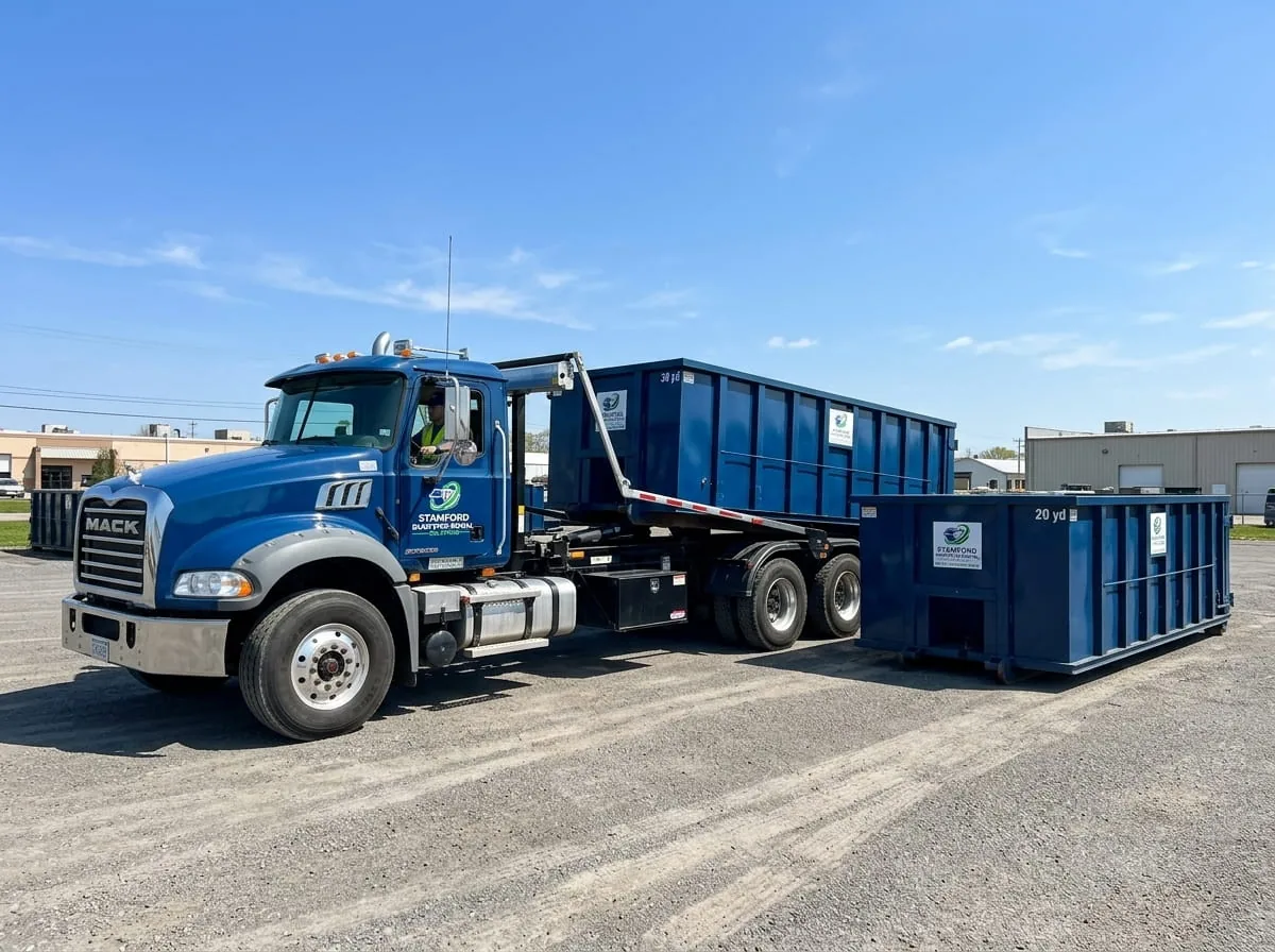 Roll-off dumpster being delivered on a residential street in Stamford CT